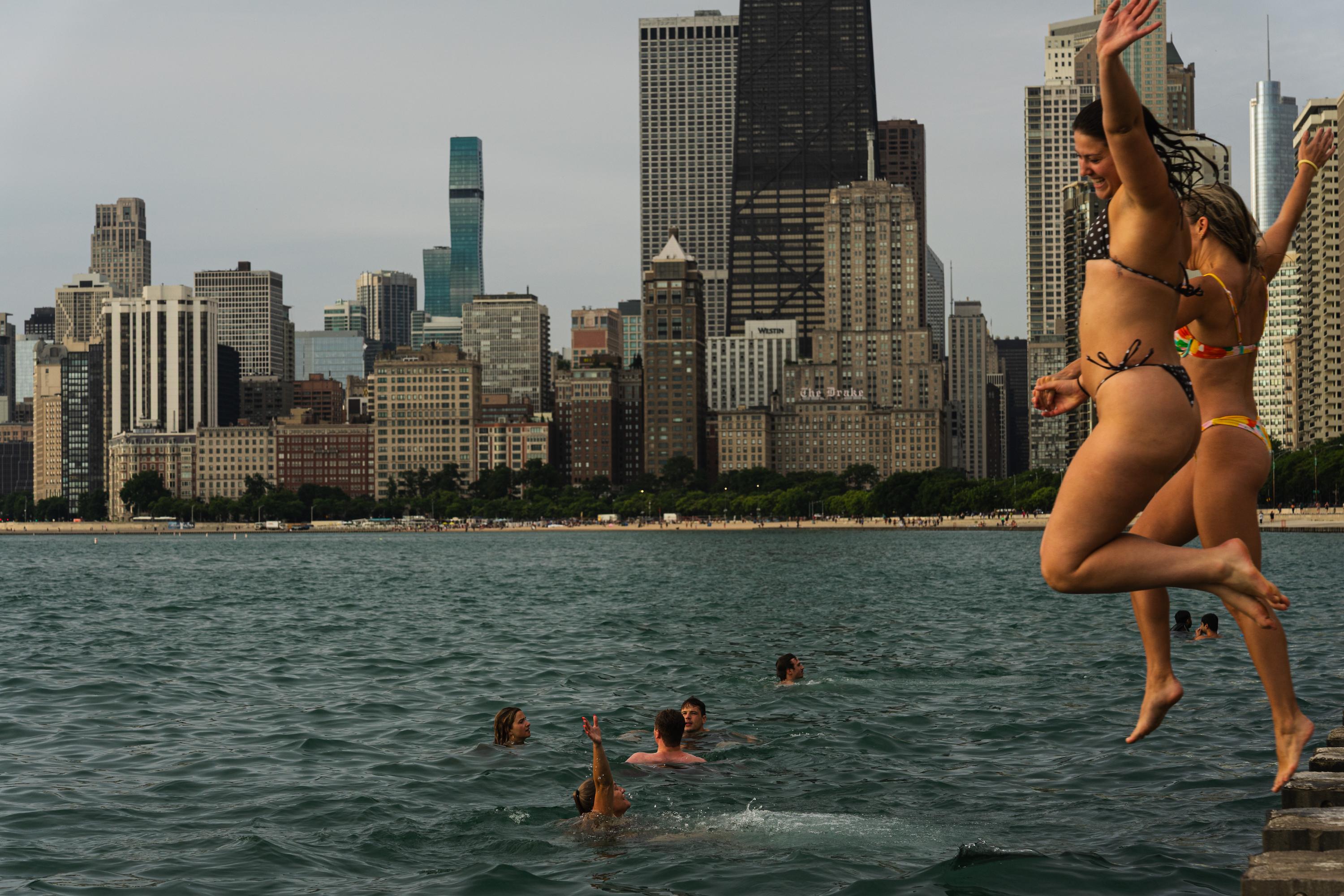 Participants jump into Lake Michigan for Frosty Fridays near the Lincoln Park Chess Pavilion on June 24, 2026.