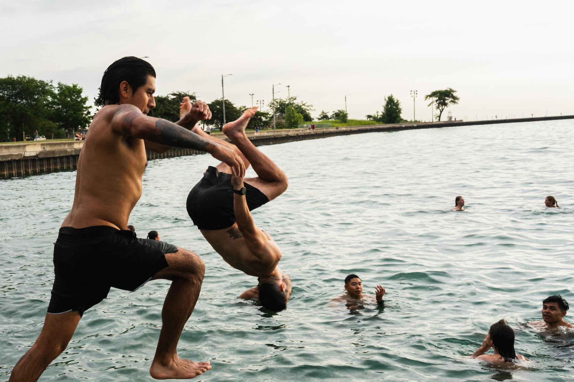 Participants jump into Lake Michigan for Frosty Fridays near the Lincoln Park Chess Pavilion on June 24, 2026.