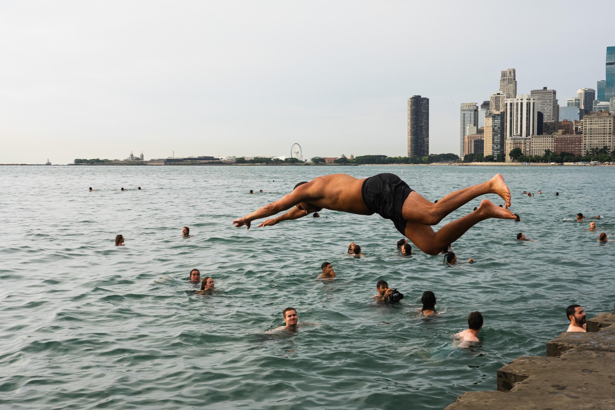 Participants jump into Lake Michigan for Frosty Fridays near the Lincoln Park Chess Pavilion on June 24, 2026.